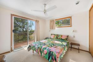 a bedroom with a bed and a window at Yurung, 26 Dulconghi Street in Crescent Head