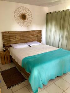 a bedroom with a large bed with a wooden headboard at “Mar doce Lar” in Lauro de Freitas