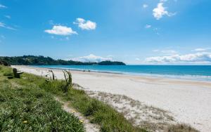 una playa de arena con el océano en el fondo en Onetangi Beach Stays Studio 2 - Coast & Country, en Onetangi