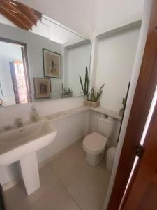 a bathroom with a sink and a toilet and a mirror at Verano eterno entre montañas 