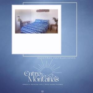 a picture of a bed with a blue comforter at Verano eterno entre montañas 