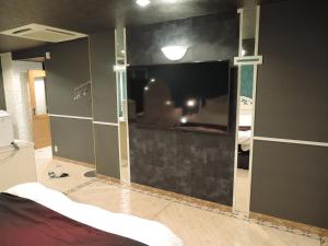 a room being remodeled with a glass wall at Hotel M in Oyodo