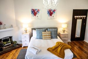 a bedroom with a bed with two night stands and two lamps at Fairleys of Corowa in Corowa