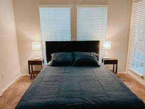 a bedroom with a large bed with two lamps at Warm 2-Bedroom Amongst Shaded Oaks in Corpus Christi