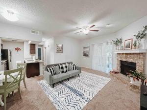 a living room with a couch and a fireplace at Warm 2-Bedroom Amongst Shaded Oaks in Corpus Christi