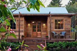 a wooden cabin with two chairs on a deck at Old Bishop's Quarters in Hobart +8 photos