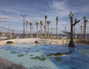 a pool of water with animals in it with palm trees at 1 BD Apt close to Disney/Universal/Shopping/Dining in Kissimmee
