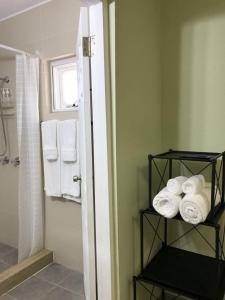 a bathroom with a stack of towels on a shelf at Ocean Villa Guam in Tamuning