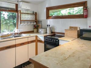 a kitchen with a stove and a counter top at The Lodge in Uny Lelant