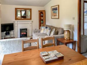 a living room with a couch and a table at The Lodge in Uny Lelant