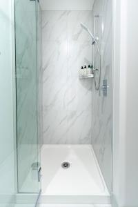 a bathroom with a shower with a glass door at Central Sunny Perch 2 bed 1 bath in Christchurch