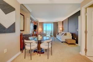 a living room with a table and chairs and a couch at MGM Signature Upgraded 1BD/2BTH SUITE w/BALCONY in Las Vegas