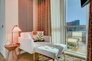 a living room with a chair and a window at MGM Signature Upgraded 1BD/2BTH SUITE w/BALCONY in Las Vegas +41 photos