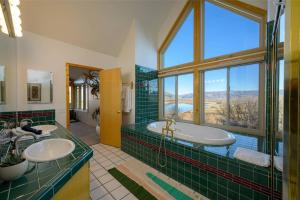 a bathroom with two sinks and a large window at Snowbasin + Powder Mountain + Spa + Eden in Eden