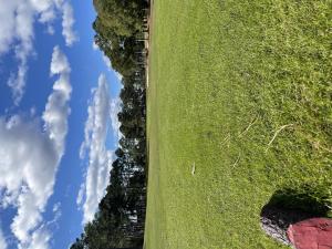 an aerial view of a green field with a blue sky at Brunswick Plantation Studio Home 1301L in Calabash