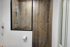 a shower with a glass door in a bathroom at Charming studio in the historic centre in Montpellier