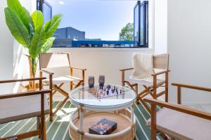 a room with chairs and a chess board on a glass table at Central Sunny Perch 2 bed 1 bath in Christchurch
