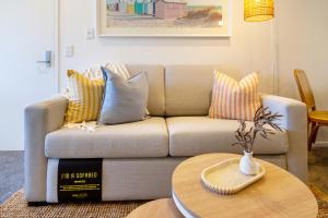 a living room with a couch and a table at Central Sunny Perch 2 bed 1 bath in Christchurch