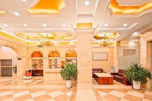 a lobby with two potted plants in a building at Vienna Hotel Shenzhen International Airport in Bao'an