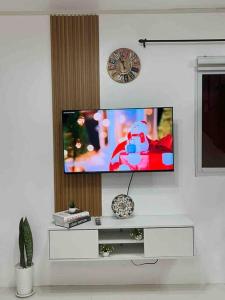 a flat screen tv on a wall in a living room at Cozy Staytion House at Camella Homes Vigan City in Bantay