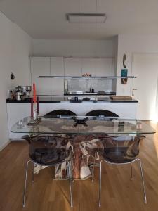 a glass table in the middle of a kitchen at Luxury, Spacious, Sunny home in the heart of Berlin in Berlin