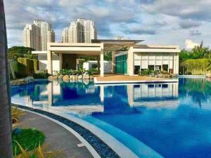 a house with blue water in front of it at Kasara Resort Condotel by Vhi in Manila