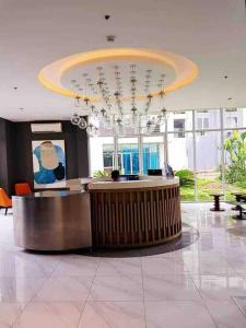 a lobby with a reception desk in a building at Kasara Condo Staycation by Vhi in Manila +38 photos