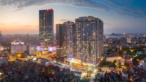 een stad verlicht in de nacht met hoge gebouwen bij luxury Serviced Apartment Vinhomes Metropolis Premium in Hanoi