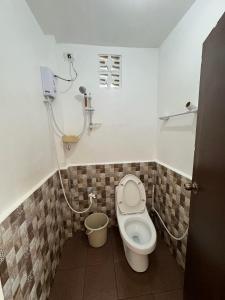 a small bathroom with a toilet and a sink at Alona Bohol Backpackers Hostel in Panglao