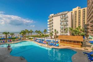 默特爾海灘的住宿－Breathtaking Oceanfront 3BR,2BA Suite/Grand Cayman 451，一个带椅子的度假游泳池和一间酒店