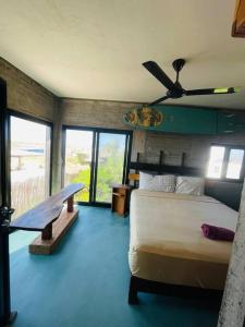 a bedroom with a bed and a ceiling fan at Casa Vista Hermosa in San Juanico