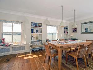 a dining room with a wooden table and chairs at Haven View in Neyland