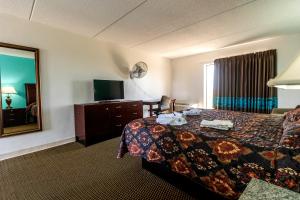 a hotel room with a bed and a mirror at CRYSTAL PALACE RESORT in Bolivar Peninsula