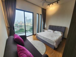 a bedroom with a bed and a couch and a window at Beacon Executive Suites - George Town in George Town +178 photos