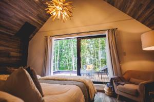 OiwakeにあるSAUNA FOREST CABIN Karuizawa Miyota - Vacation STAY 23176vのベッドルーム1室(ベッド1台、大きな窓付)