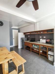 a large kitchen with a wooden table and a counter at Private Guest House Bay Breeze in San Juan