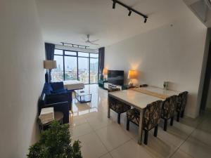 a living room with a dining room table and a couch at Beacon Executive Suites in George Town
