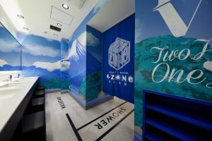 a bathroom with a blue and green wall at esports hotel e-ZONe 電脳空間 in Osaka