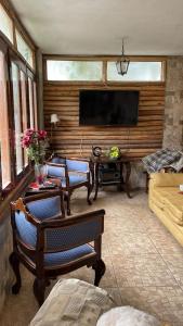 a living room with a flat screen tv and a couch at Villa Del Solar in Asia