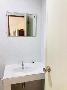 a bathroom with a sink and a mirror at Wiriya House in Chiang Mai