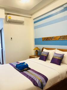 Postel nebo postele na pokoji v ubytování Wiriya House