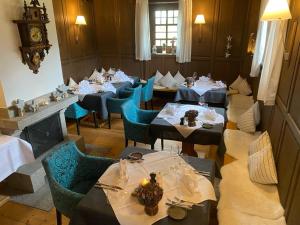 a dining room with tables and blue chairs at Schwarzwaldhof Nicklas in Bonndorf im Schwarzwald