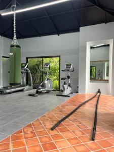 a gym with treadmills and exercise equipment on the floor at Palm Galleria Resort in Khao Lak