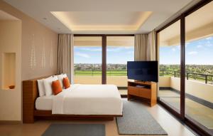 a bedroom with a bed and a flat screen tv at Hyatt Place Bodh Gaya in Bodh Gaya