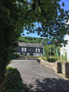 a large black house with flags in front of it at Old Boathouse Upper Lough Erne in Fairfield