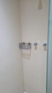 a bathroom with a toilet with two baskets on the wall at Angra inn, Angra dos Reis in Angra dos Reis