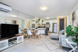a living room with a large flat screen tv at Amazing Water Views Surfers Paradise in Gold Coast