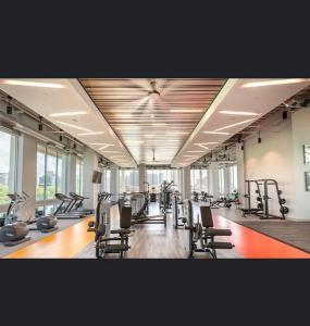 a gym with a lot of treadmills and machines at Luxurious & cozy 2bedroom/2bath apt downtwn Dallas in Dallas