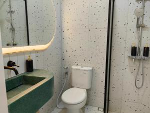 een badkamer met een toilet, een wastafel en een douche bij Haha house in Padalarang