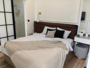 a bedroom with a large bed with black and white pillows at Haha house in Padalarang